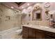 Elegant bathroom with marble tile, glass shower, dark wood vanity and decorative gold mirror at 114 Lees Lake Rd, Fayetteville, GA 30214