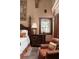 Bedroom featuring a decorative leaded-glass window, vintage furniture, and rich wooden trim at 114 Lees Lake Rd, Fayetteville, GA 30214