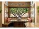 Charming breakfast nook features a custom banquette seating and window with gorgeous outdoor views at 114 Lees Lake Rd, Fayetteville, GA 30214