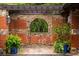 Detailed view of a courtyard wall with unique window and greenery at 114 Lees Lake Rd, Fayetteville, GA 30214