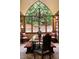 This elegant dining room boasts a cathedral window, chandelier, and seating for memorable gatherings at 114 Lees Lake Rd, Fayetteville, GA 30214