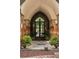 Close-up of arched portico entrance, showing custom double doors and brick-and-stone details at 114 Lees Lake Rd, Fayetteville, GA 30214