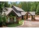 Beautiful exterior elevation showing the portico entrance, and lush greenery framing the house at 114 Lees Lake Rd, Fayetteville, GA 30214