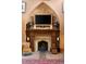 A stone fireplace and mantel with ornate details and decorative accessories at 114 Lees Lake Rd, Fayetteville, GA 30214