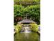 Close-up of a backyard fountain and pond surrounded by lush greenery at 114 Lees Lake Rd, Fayetteville, GA 30214