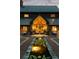 Stunning front view of custom home with water feature leading to a grand, arched entryway and manicured landscaping at 114 Lees Lake Rd, Fayetteville, GA 30214