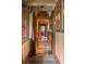 Hallway featuring decorative curtains, wooden cabinets, and beautiful lighting at 114 Lees Lake Rd, Fayetteville, GA 30214