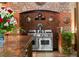 Chef's kitchen featuring high-end appliances, custom brickwork and a granite counter at 114 Lees Lake Rd, Fayetteville, GA 30214