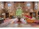 Spacious living room featuring abundant seating, dramatic window, Persian rug, and vintage lighting at 114 Lees Lake Rd, Fayetteville, GA 30214