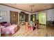 Living room featuring hardwood floors, vintage armoire, and seating around a round table at 114 Lees Lake Rd, Fayetteville, GA 30214