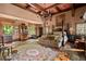 Spacious main bedroom with a four-poster bed, sitting area, and large windows with nature views at 114 Lees Lake Rd, Fayetteville, GA 30214