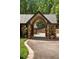 Close up on home's covered portico and stone and brick columns and manicured landscape at 114 Lees Lake Rd, Fayetteville, GA 30214