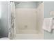 Bathtub/shower featuring white tiles, a shower curtain, and a towel rack with a fresh towel at 207 Lees Lake Rd, Fayetteville, GA 30214