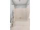 Clean white tiled bathtub/shower area with a shower curtain and convenient towel rack for easy access at 207 Lees Lake Rd, Fayetteville, GA 30214
