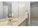 Bathroom showcasing a vanity with a faucet, mirror, towel rack, and a glimpse of the bathtub/shower area at 207 Lees Lake Rd, Fayetteville, GA 30214