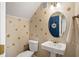 Small bathroom with peach wall decals and a pedestal sink at 207 Lees Lake Rd, Fayetteville, GA 30214