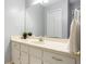 Well-lit bathroom with a large mirror, vanity with storage, and a clean, neutral color scheme at 207 Lees Lake Rd, Fayetteville, GA 30214