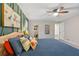 Bedroom featuring a bed with colorful pillows, an accent wall, and closet at 207 Lees Lake Rd, Fayetteville, GA 30214