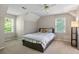 Bedroom featuring two windows, a bed, and a lamp at 207 Lees Lake Rd, Fayetteville, GA 30214