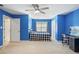 Blue bedroom featuring a bed, desk, and closet at 207 Lees Lake Rd, Fayetteville, GA 30214