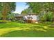 Rear exterior of home with well-manicured backyard and large screened porch, perfect for outdoor living at 207 Lees Lake Rd, Fayetteville, GA 30214