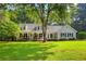 Charming one-story home featuring a welcoming front porch with rocking chairs and lush landscaping at 207 Lees Lake Rd, Fayetteville, GA 30214