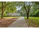 Scenic view of home with a long driveway and lush greenery at 207 Lees Lake Rd, Fayetteville, GA 30214
