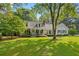 Charming home with a welcoming front porch, rocking chairs, and a beautifully landscaped lawn at 207 Lees Lake Rd, Fayetteville, GA 30214