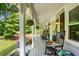 Relaxing front porch with rocking chairs, hanging plants, and a serene view of the surrounding greenery at 207 Lees Lake Rd, Fayetteville, GA 30214