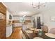 Eat-in kitchen featuring white cabinets, an island, stainless steel appliances, and a brick wall at 207 Lees Lake Rd, Fayetteville, GA 30214