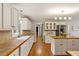 Spacious kitchen featuring white cabinets, tan countertops, and stainless steel appliances at 207 Lees Lake Rd, Fayetteville, GA 30214