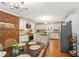 Eat-in kitchen featuring white cabinets, an island, stainless steel appliances, and a brick wall at 207 Lees Lake Rd, Fayetteville, GA 30214