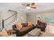 Spacious living room with hardwood floors, comfortable seating, and access to a bright sunroom at 207 Lees Lake Rd, Fayetteville, GA 30214