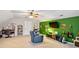 Spacious living area boasts comfortable seating, a green accent wall, and entertainment setup for relaxation and enjoyment at 207 Lees Lake Rd, Fayetteville, GA 30214