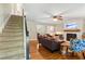 Cozy living room with hardwood floors, a fireplace, and comfortable seating near the staircase at 207 Lees Lake Rd, Fayetteville, GA 30214