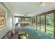 Relaxing screened-in porch featuring comfortable seating and ceiling fans, perfect for enjoying the outdoors at 207 Lees Lake Rd, Fayetteville, GA 30214