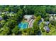 Aerial view of the community pool, tennis courts, playground, and lush green landscaping at 2688 Beddington Way, Suwanee, GA 30024