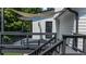 View of a back deck featuring a sun shade, black railings, and a door leading into the home at 2688 Beddington Way, Suwanee, GA 30024