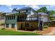 Expansive backyard view of a two-story home featuring a covered deck and an outdoor patio area at 2688 Beddington Way, Suwanee, GA 30024