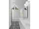 Bright bathroom featuring dual sinks, an enclosed shower and a triangular picture window at 2688 Beddington Way, Suwanee, GA 30024