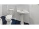 Compact bathroom featuring pedestal sink and blue-and-white tile flooring at 2688 Beddington Way, Suwanee, GA 30024