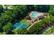 Aerial view of the community pool and tennis courts surrounded by lush greenery at 2688 Beddington Way, Suwanee, GA 30024