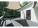 Wood deck with sun shade, bench, and wooded backyard at 2688 Beddington Way, Suwanee, GA 30024