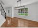 Bright dining room with hardwood floors, large window, and contemporary light fixture near the stairs at 2688 Beddington Way, Suwanee, GA 30024