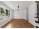 Bright dining room with hardwood floors, large window, and contemporary light fixture at 2688 Beddington Way, Suwanee, GA 30024