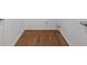 Empty room with hardwood flooring and white trim, creating a clean and versatile space at 2688 Beddington Way, Suwanee, GA 30024