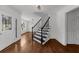 Elegant foyer with wooden staircase, dark iron spindles, and front door with stained glass at 2688 Beddington Way, Suwanee, GA 30024