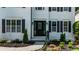 Front door entrance featuring sidelights, black shutters, and manicured landscaping around the walkway at 2688 Beddington Way, Suwanee, GA 30024