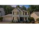Charming two-story home featuring black shutters, a lush lawn, and well-maintained landscaping at 2688 Beddington Way, Suwanee, GA 30024