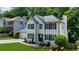 Charming two-story home with manicured landscaping, a well-maintained lawn, and a welcoming front entrance at 2688 Beddington Way, Suwanee, GA 30024